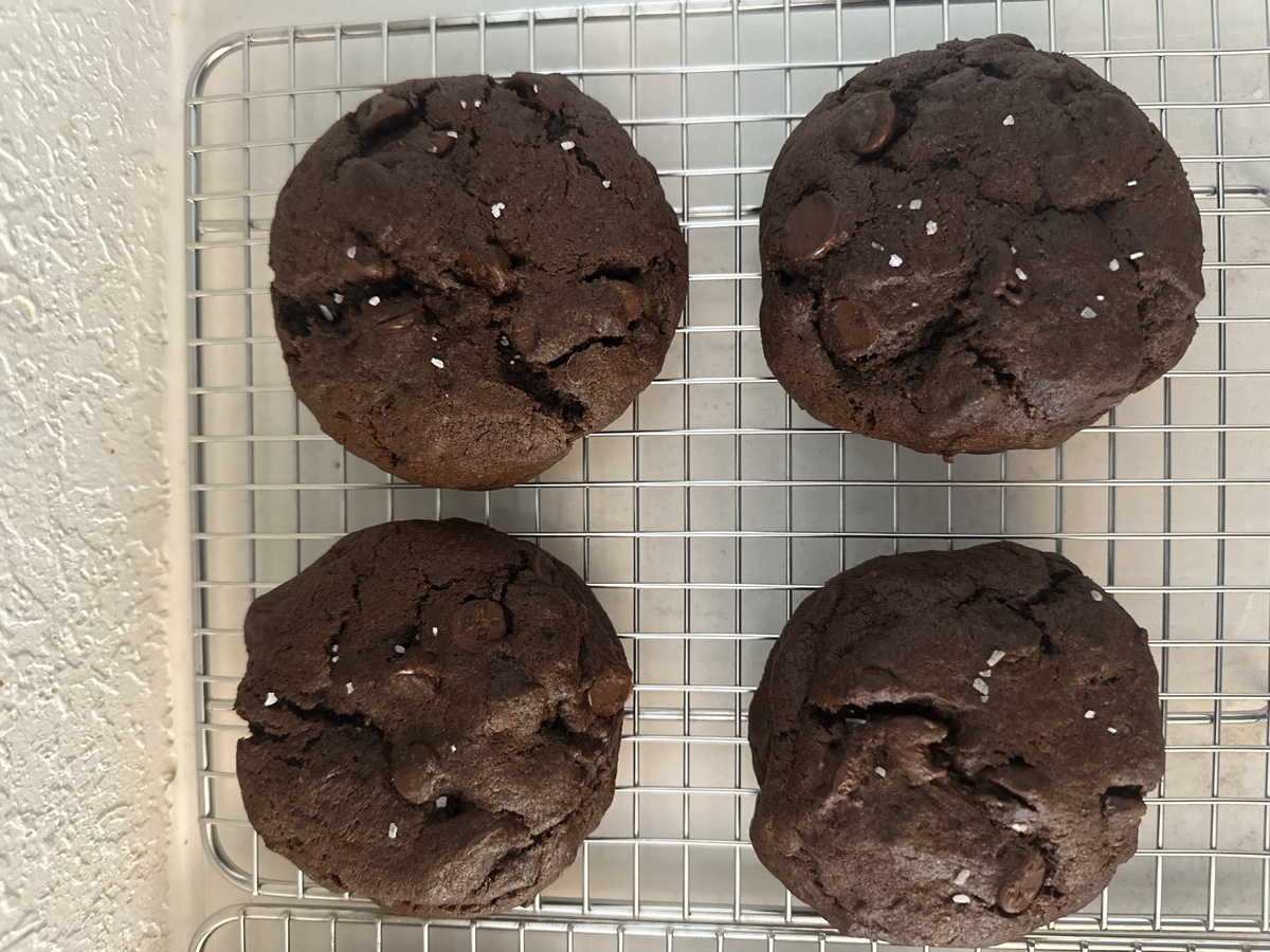 Four sourdough double chocolate cookies topped with flaky sea salt